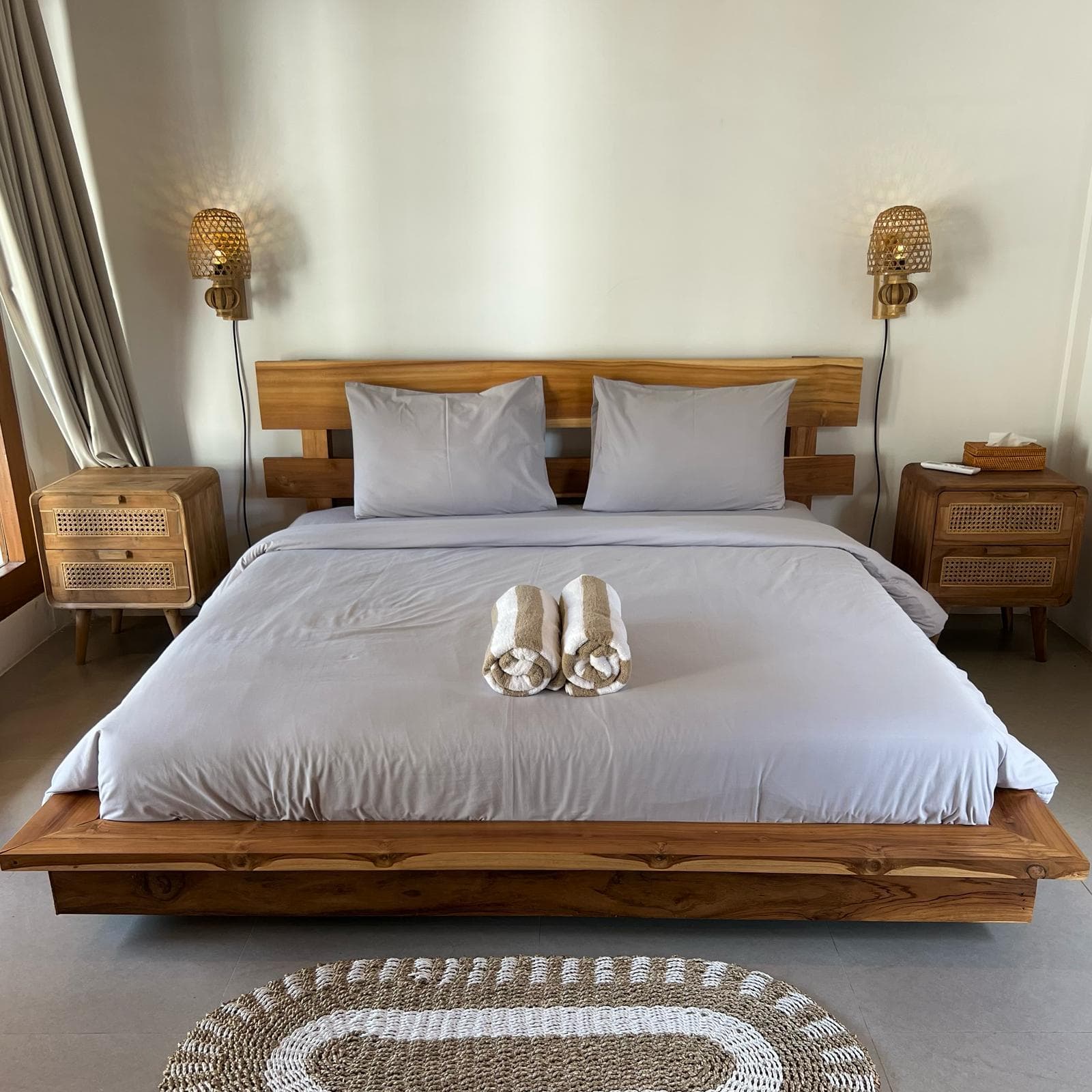 Queen bed in teak with rattan bedside tables