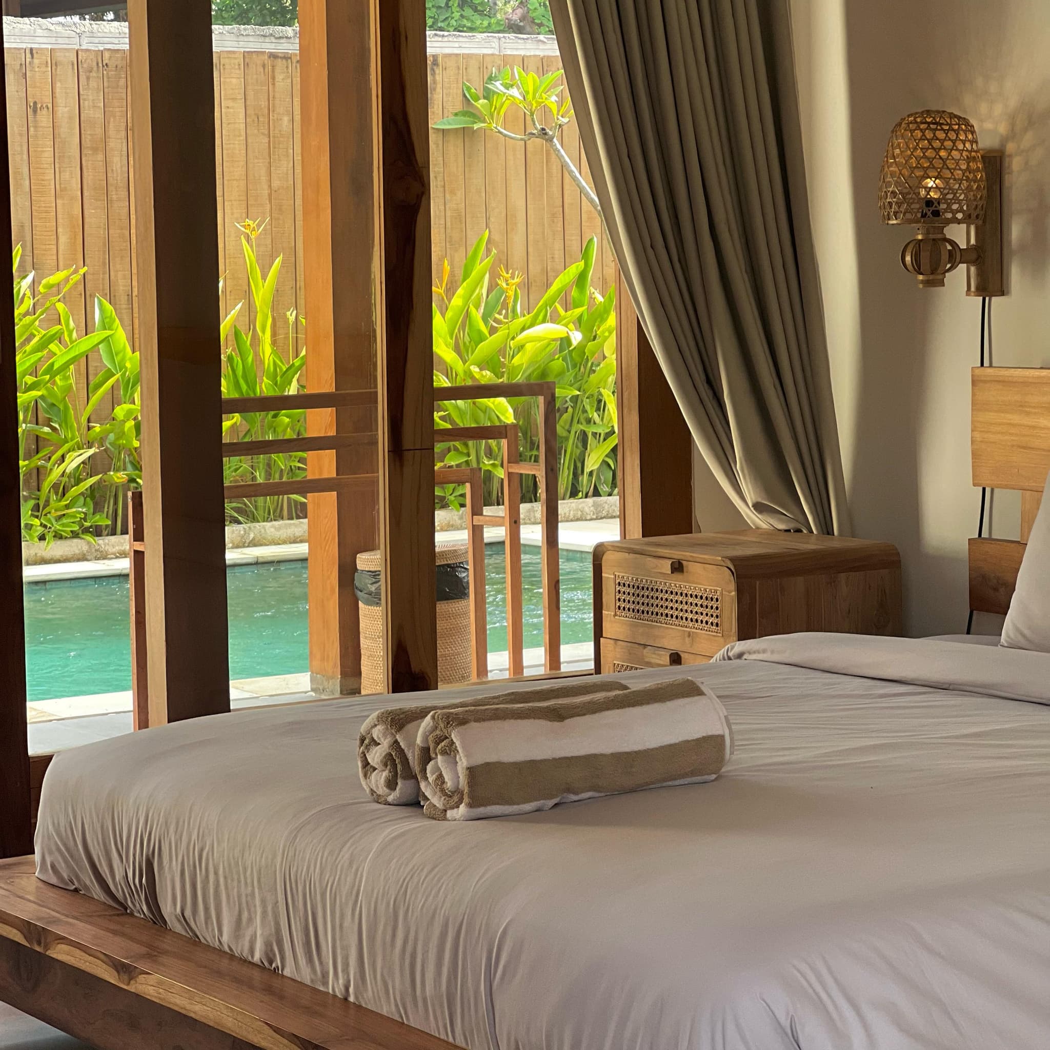 Bedroom with towels and pool view